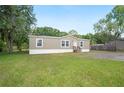 Cozy home with a green lawn and a charming front entrance at 6433 Mangrove Dr, Wesley Chapel, FL 33544