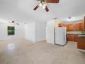 Open-concept living area with tile flooring and a partial view into the functional kitchen at 3205 N 66Th St, Tampa, FL 33619