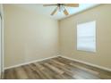 Cozy bedroom with wood-look flooring, a ceiling fan, and a window allowing natural light at 3419 Trapnell Ridge Dr, Plant City, FL 33567