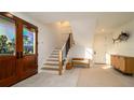 Bright foyer with staircase, bench seating and stylish decor at 531 68Th St, Holmes Beach, FL 34217