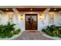 Elegant double front doors with sidelights flanked by tropical landscaping at 531 68Th St, Holmes Beach, FL 34217