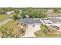 Sprawling single-story home with a three-car garage, lush landscaping, and extended driveway at 11447 Adelia St, Spring Hill, FL 34608