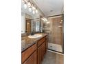 Bathroom featuring granite countertop, framed mirror, and a glass shower at 12654 Belcroft Dr, Riverview, FL 33579