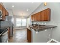 Modern kitchen with stainless steel appliances and granite countertop bar area at 12654 Belcroft Dr, Riverview, FL 33579