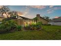 Lush backyard featuring a screened-in lanai and mature tropical landscaping at 2912 Aston Ave, Plant City, FL 33566