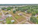 Wide aerial view of a sprawling property with a home, outbuildings, and a white perimeter fence at 3715 Fortner Rd, Plant City, FL 33567