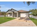 Lovely single-story home showcasing a manicured lawn and convenient attached two car garage at 5227 Lime Ave, Seffner, FL 33584