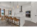 Bright kitchen featuring a large island, pendant lighting, and stainless steel appliances at 5227 Lime Ave, Seffner, FL 33584