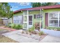 Quaint front porch featuring stylish bars, a seating area, and inviting landscaping at 10804 N Leo St, Tampa, FL 33612