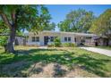 Inviting single-story home with a covered carport and neatly landscaped front yard at 6011 67Th N Ave, Pinellas Park, FL 33781