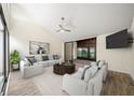Bright living room featuring neutral walls, vaulted ceilings, and sliding door to screened patio at 107 Seville N Ct, Plant City, FL 33566