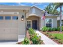 Inviting home entrance featuring a blue door with wreath, landscaped walkway, and a well-lit entry at 1233 Emerald Hill Way, Valrico, FL 33594