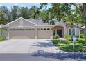 Inviting single-story home boasts a three-car garage, manicured landscaping, and a welcoming entryway at 1233 Emerald Hill Way, Valrico, FL 33594