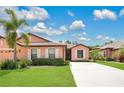 Charming one-story home featuring a well-manicured lawn, mature landscaping and concrete driveway at 163 Shell Falls Dr, Apollo Beach, FL 33572