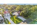 Aerial view of a property showing its expansive lot, pool, detached garage, and lush landscaping at 607 N Merrin St, Plant City, FL 33563