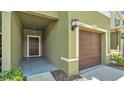 Inviting entryway with a covered porch and single car garage entrance at 2622 Lantern Hill Ave, Brandon, FL 33511