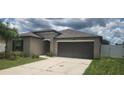 Charming single-story home with a well-maintained lawn, two-car garage, and neutral-toned exterior at 3188 Nubbin Ridge Ln, Zephyrhills, FL 33540