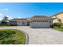 Inviting single-story home boasting a brick driveway, attached garage, and well-maintained lawn at 3626 Corsair Ct, New Port Richey, FL 34652