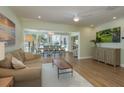 Open-concept living and dining area with wood floors and sliding glass doors to the outdoors at 3626 Corsair Ct, New Port Richey, FL 34652