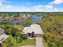 Aerial view of the property with a spacious lot, lush landscaping, and stunning waterfront access at 5903 Cachette De Riviera Ct, New Port Richey, FL 34655