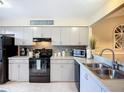 Well-equipped kitchen with modern appliances, sleek cabinets, and granite countertops, perfect for cooking at 6012 28Th W St, Bradenton, FL 34207