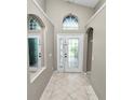 Bright foyer with tile flooring, arched windows, and neutral paint tones welcomes you into this lovely home at 16804 Hawkridge Rd, Lithia, FL 33547