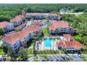 Condominium community with a pool, manicured green space, and mature landscaping creating a serene environment at 18001 Richmond Place Dr # 337, Tampa, FL 33647