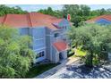 A condo building with gray facade and a red tile roof provides a cozy and attractive exterior at 18001 Richmond Place Dr # 337, Tampa, FL 33647