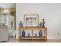 Inviting foyer featuring a stylish console table adorned with decorative vases and elegant artwork at 1909 Masters Way, Plant City, FL 33566