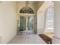 Elegant front door with decorative glass, a tiled entryway, and a charming 'Welcome' sign at 1909 Masters Way, Plant City, FL 33566