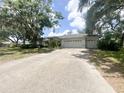 Beautiful single-story home with a two-car garage, a wide driveway, and mature trees providing ample shade at 1909 Masters Way, Plant City, FL 33566