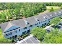 Aerial view showcasing the townhouse complex and surrounding greenery at 34852 Teeview Ln, Zephyrhills, FL 33541