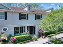 Two-story home with dark shutters and well-maintained landscaping at 34852 Teeview Ln, Zephyrhills, FL 33541