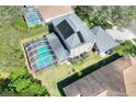 Aerial view of property showing a screened-in pool, solar panels, and well maintained landscaping at 3507 Autumn Glen Dr, Valrico, FL 33596