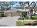 Inviting home with a three-car garage, mature trees and well-manicured lawn at 3507 Autumn Glen Dr, Valrico, FL 33596