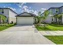 Exterior view of a well-maintained home with a spacious two-car garage and neat landscaping at 4035 Radiant Mountain Dr, Plant City, FL 33565