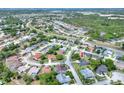 Neighborhood aerial view showcasing the property with lush greenery, a large driveway, and well-maintained landscaping at 8721 Latham Ln, Hudson, FL 34667