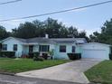 Charming single Gathering home with an attached garage and a well-maintained front yard at 1002 W La Salle St, Tampa, FL 33607