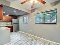 Condo kitchen featuring stainless steel appliances and adjacent dining area with backyard views at 11704 Raintree Village Blvd # B, Temple Terrace, FL 33617