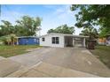 Inviting single-story home with a carport and a fresh white painted brick exterior at 1317 E Laura St, Plant City, FL 33563