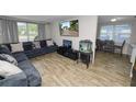 Cozy living room with hardwood floors, a sectional sofa, and a large screen TV at 1317 E Laura St, Plant City, FL 33563