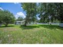 Expansive grassy backyard perfect for outdoor activities, with mature trees and a peaceful setting at 3611 Maxwell Rd, Plant City, FL 33566