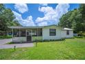 Charming single-story home with a well-maintained lawn, screened porch, and inviting curb appeal at 3611 Maxwell Rd, Plant City, FL 33566