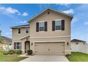 Charming exterior view of a two-story home with a well-maintained lawn at 503 Arbequina Ct, Plant City, FL 33566