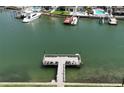 Aerial view of a T-shaped dock with boats docked nearby, providing easy access to waterfront activities and scenic views at 1893 Shore S Dr # 208, South Pasadena, FL 33707