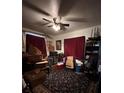 Bedroom with a ceiling fan, two windows and dark blue patterned carpet at 4108 W Euclid Ave, Tampa, FL 33629