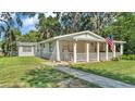 Charming home with well-maintained lawn, walkway, and cozy covered front porch at 4818 Huron St, Zephyrhills, FL 33541