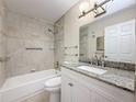 Updated bathroom featuring a shower/tub combo with modern fixtures and granite countertops at 5980 80Th N St # 408, St Petersburg, FL 33709