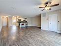 Spacious living room area featuring sleek wood-look flooring and a ceiling fan at 5980 80Th N St # 408, St Petersburg, FL 33709