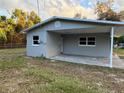 Rear exterior view showing the carport and the new siding of the single-story home at 14002 Morgan St, Dade City, FL 33525